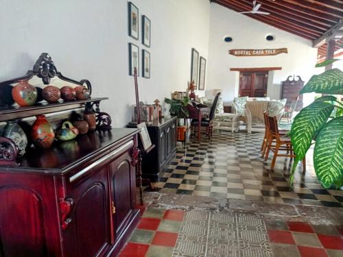 a living room with a checkered floor at Casa Yoly Hostel Granada in Granada