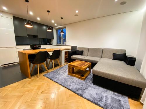 a living room with a couch and a kitchen at Luxury Apartment in the City Centre in Košice
