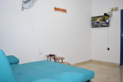 a hospital room with a blue couch and a table at HOSTAL LA MACARENA in El Zaino