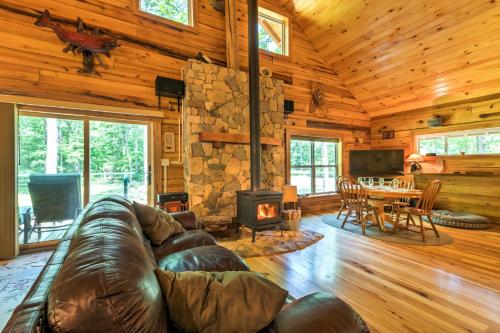 a living room with a leather couch and a fireplace at Lyndhurst Cabin on Farm with Pond and Stocked Stream! in Lyndhurst
