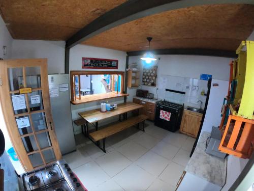 an overhead view of a kitchen with a table and stove at Rey Lagarto Hostel in San Pedro de Atacama