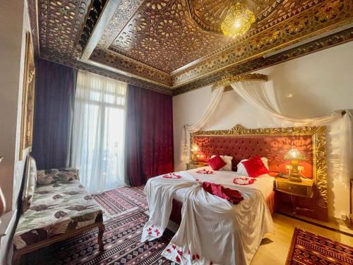 a bedroom with two beds and a gold ceiling at Royal Victoria - Ex British Embassy in Tunis