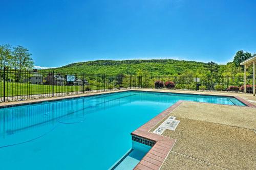 a swimming pool with a fence and mountains in the background at Hike, Bike and Swim Mountain Escape with Deck in Clear Spring