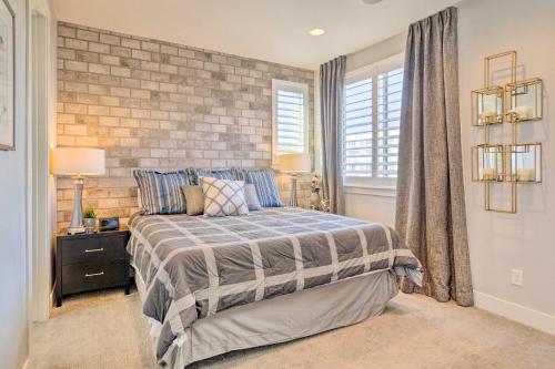 um quarto com uma cama e uma parede de tijolos em Pet-Friendly Denver Escape with Private Balcony em Denver