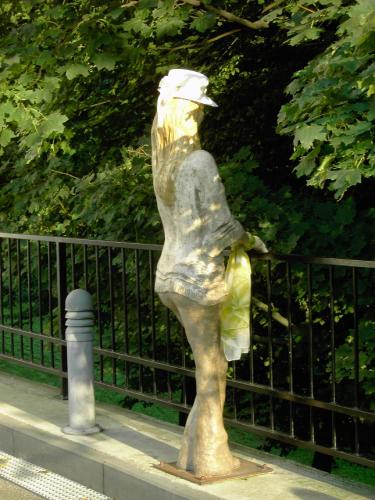 a statue of a woman standing next to a fence at Hotel Zámecká Sýpka in Blansko