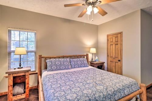 a bedroom with a bed and a ceiling fan at Heber Springs Cabin about 1 Mi to Sugarloaf Mtn! in Heber Springs