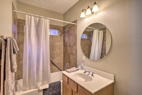 a bathroom with a sink and a shower and a mirror at Heber Springs Cabin about 1 Mi to Sugarloaf Mtn! in Heber Springs