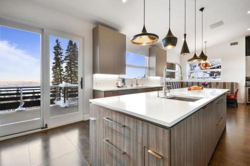 a kitchen with white countertops and a large window at Ski Palace in Park City