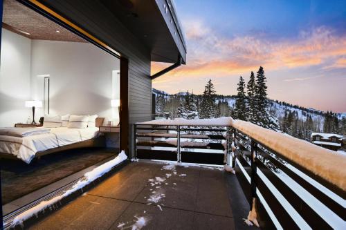 a bedroom with a bed on a balcony with a mountain view at Ski Palace in Park City