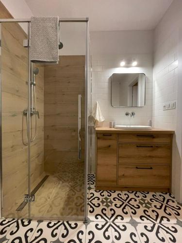 a bathroom with a shower and a sink at APARTAMENTY GUZIK in Krosno