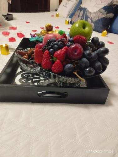 a bowl of fruit on a tray on a table at Pousada da Paz in Curitiba