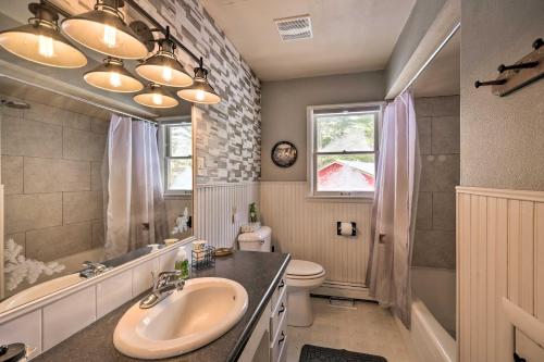 a bathroom with a sink and a toilet at Beautiful Chetek Home with Prairie Lake Access! in Chetek