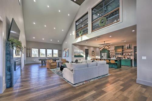 a living room with a white couch and a table at Lavish Riverfront Escape with Gas Grill! in Glenwood
