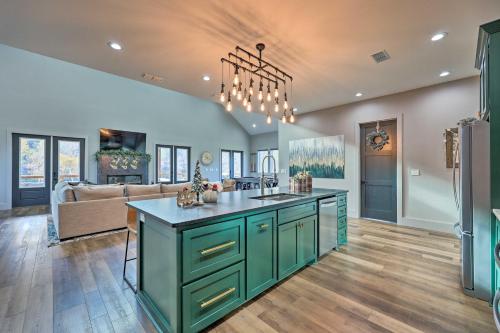 a kitchen with a green island in the middle of a room at Lavish Riverfront Escape with Gas Grill! in Glenwood