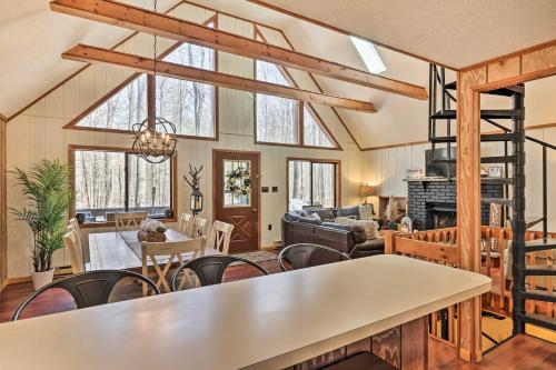 a living room with a table and chairs at Fire Pit and Grill Woodside Nest in Pocono Lake! in Pocono Lake