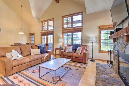 a living room with couches and a fireplace at Ski-InandSki-Out Donnelly Townhome with Hot Tub! in Donnelly