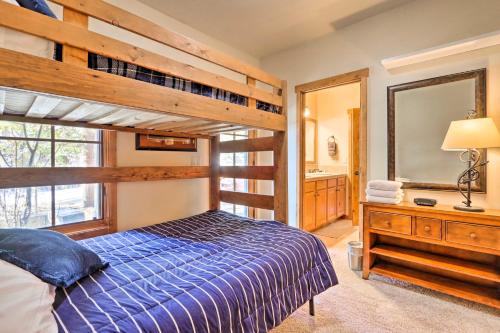 a bedroom with a bunk bed and a mirror at Ski-InandSki-Out Donnelly Townhome with Hot Tub! in Donnelly