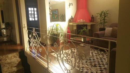 a living room with a wrought iron railing at Pousada da Paz in Curitiba
