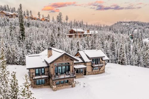 an aerial view of a log home in the snow at 360 Chalet in Big Sky