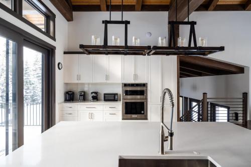 a kitchen with white cabinets and a sink at 360 Chalet in Big Sky