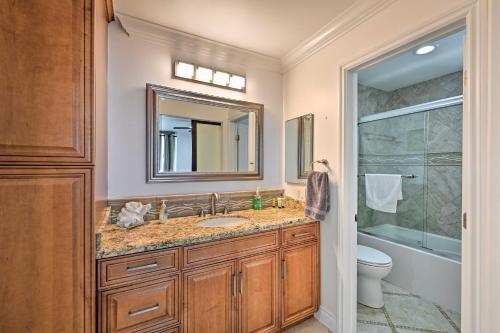 a bathroom with a sink and a toilet and a mirror at Beachfront Oceanside Condo with Amenity Access! in Oceanside