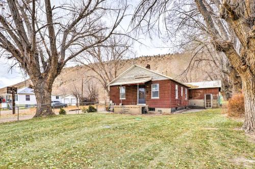 a red brick house in a yard with trees at Cozy Helper Home with Fenced Yard, Pets Welcome in Helper