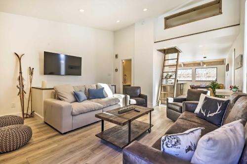 a living room with a couch and a table at Chic Condo with Fireplace Walk to Main St Frisco! in Frisco