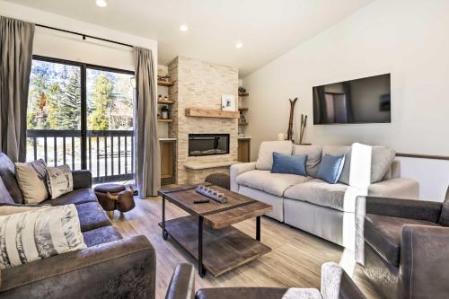 a living room with a couch and a table at Chic Condo with Fireplace Walk to Main St Frisco! in Frisco