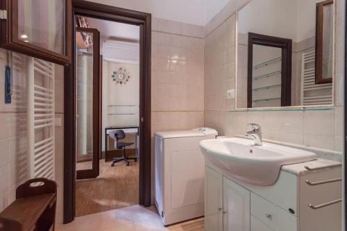 a bathroom with a sink and a washing machine at Vatican Flat Cozy with Terrace in Rome