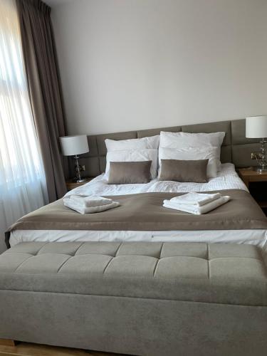 a bedroom with a large bed with two pillows at Apartamenty Saline in Inowrocław
