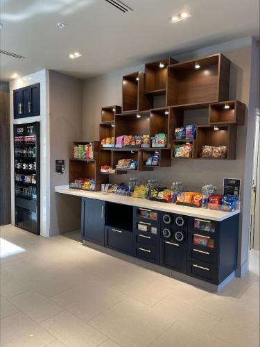a store with a counter and shelves with food at Cambria Hotel Minneapolis Downtown in Minneapolis