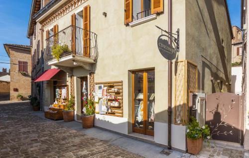 a store on a street with potted plants in front at Civiconove Affittacamere in Gradara