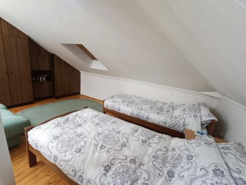 a bedroom with two beds in a attic at Apartman Ferhadija Saraj in Sarajevo