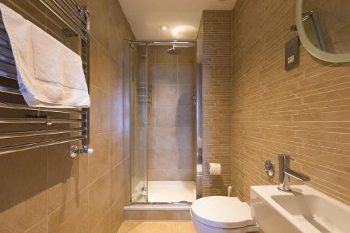 a bathroom with a shower and a toilet and a sink at Beach Haven in Carbis Bay