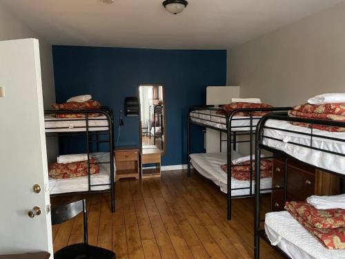 a room with a bunch of bunk beds at Auberge du Monde in Trois-Rivières