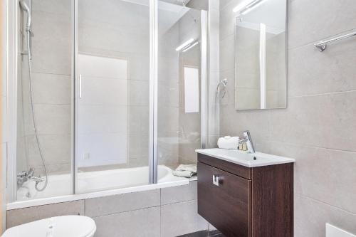 a bathroom with a shower and a toilet and a sink at Praia Mar by OCvillas in Albufeira