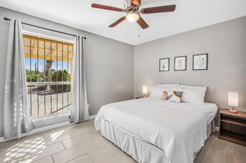 a bedroom with a bed and a ceiling fan at Cathay Place in Tucson