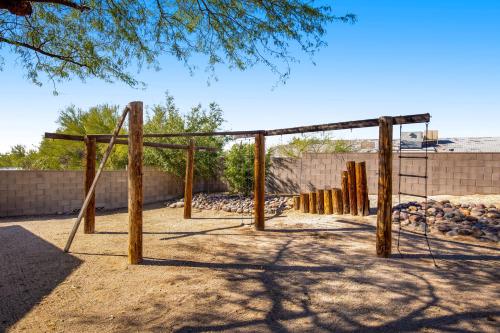 a playground with wooden posts and a swing set at Cathay Place in Tucson