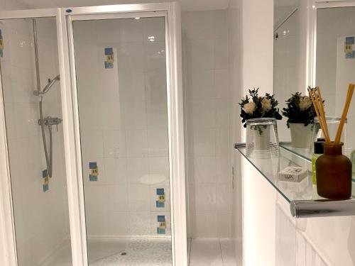 a bathroom with a shower and a glass shelf at The Crown & Victoria Inn in Tintinhull