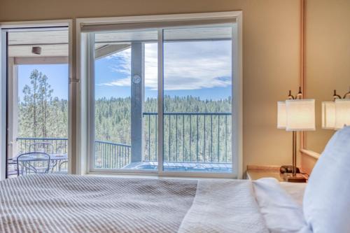 a bedroom with a bed and a large window at River Ridge 332AB in Bend