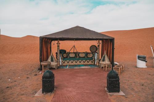 a tent in the middle of the desert at Camel Trips Luxury Camp in Merzouga