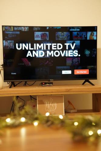 a television screen with the words unlimited tv and movies at Klek 77 Luxury Chalets near Jahorina in Paočići