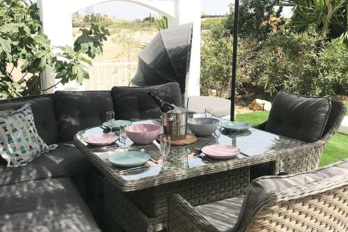 a table with bowls and plates on a couch at Casa Alegria in Antas