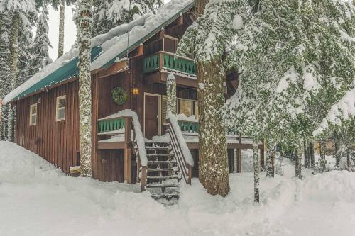 a log cabin in the snow with a snow covered at Moosewood Cabin - Meredith Lodging in Government Camp