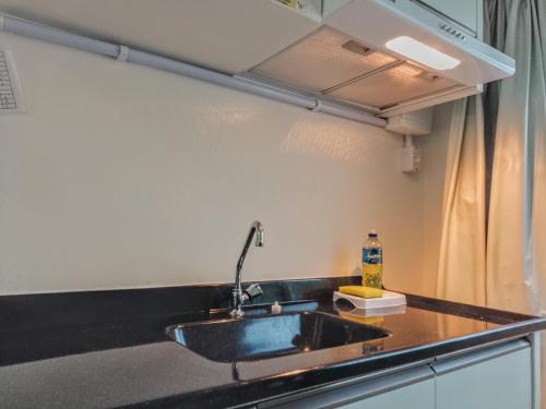 a kitchen with a sink and a counter top at Flat Sol in Balneário Camboriú