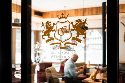 a window of a restaurant with a sign that reads guild cities werewolves at Melchtal Resort Apart Hotel in Melchtal