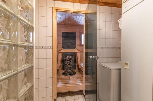 La salle de bains est pourvue d'une douche à l'italienne et de toilettes. dans l'établissement Chalet cheminee sauna PAS DE DRAP PAS DE SERVIETTE MENAGE COMPRIS, à Sirkka