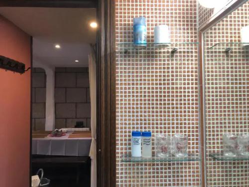 y baño con ducha y pared de azulejos. en Apartamento Cervantes - Piedad Fernandez Fernandez Gestión de Inmuebles SL, en Béjar