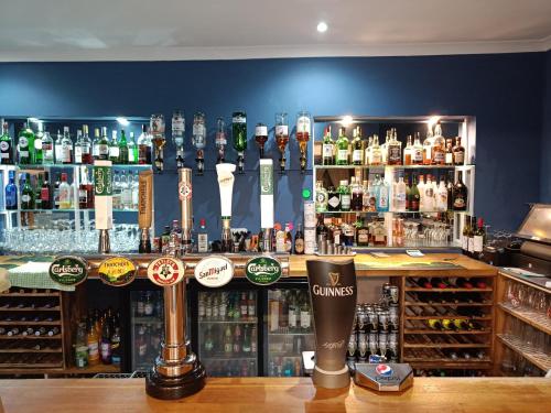a bar with a lot of bottles of alcohol at Torbay Court Hotel in Paignton