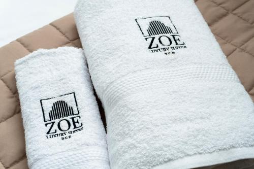 two white towels sitting on top of a bed at ZOE LUXURY SUITES in Catania